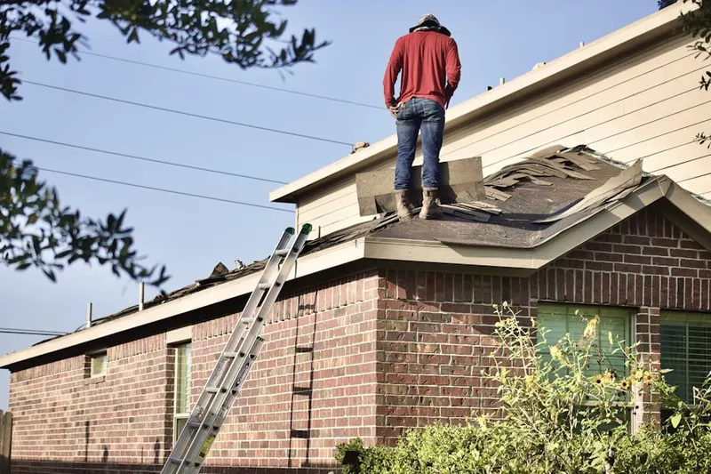 Professional roofer working on a residential roof in Zenith